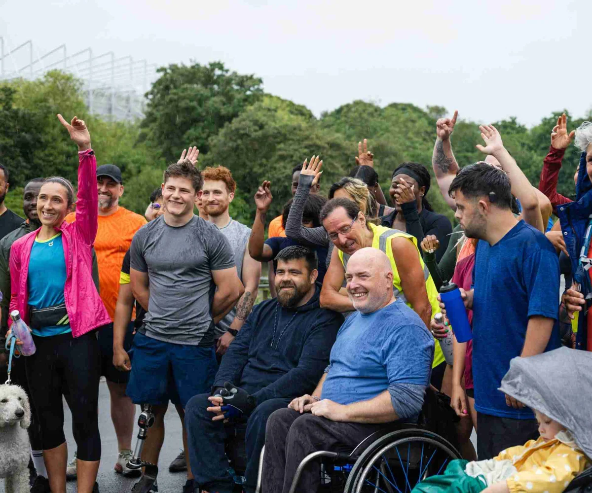 People In Exercise Clothes Raising Their Hands Getting Ready For A Race