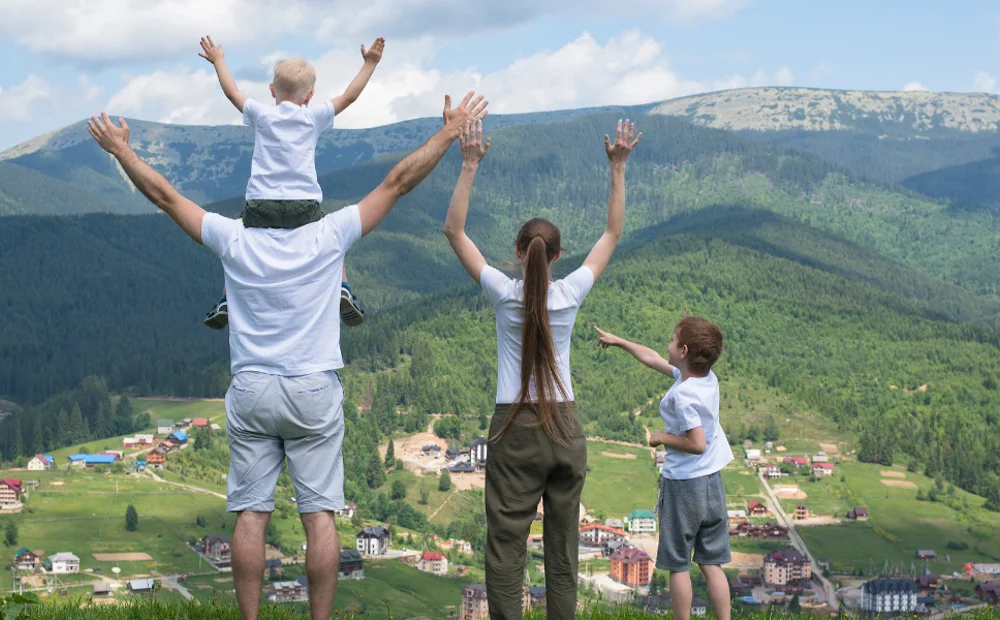 family of four standing on cliff family of four standing on cliff