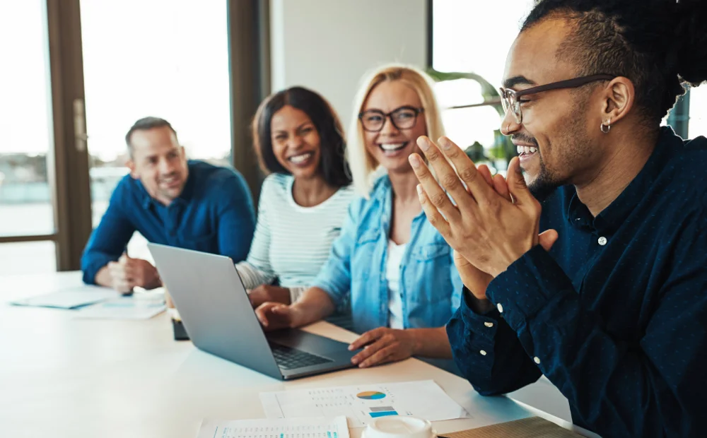 group of people smiling and laughing at work group of people smiling and laughing at work