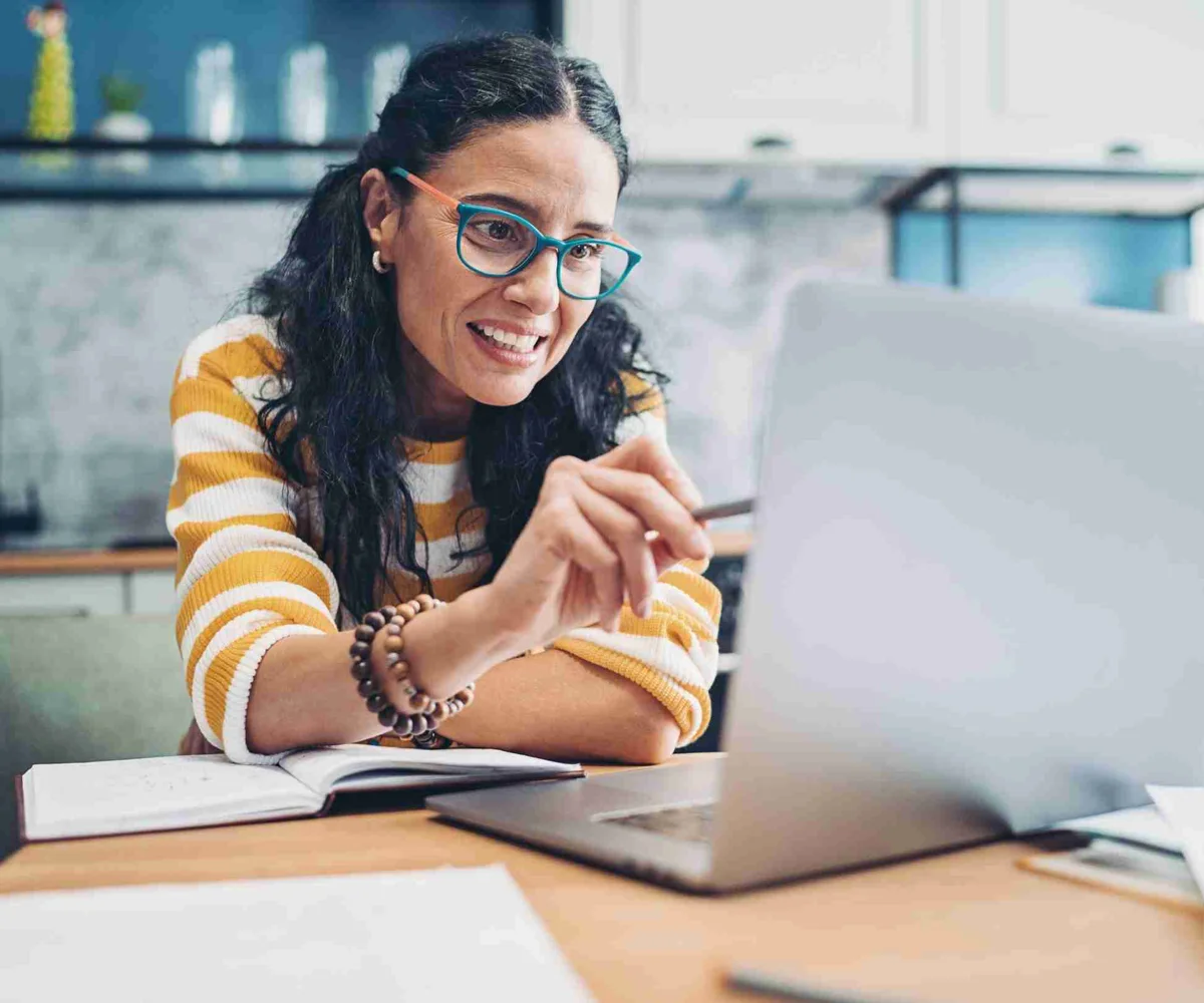 Woman Smiling Pointing At Laptop Screen
