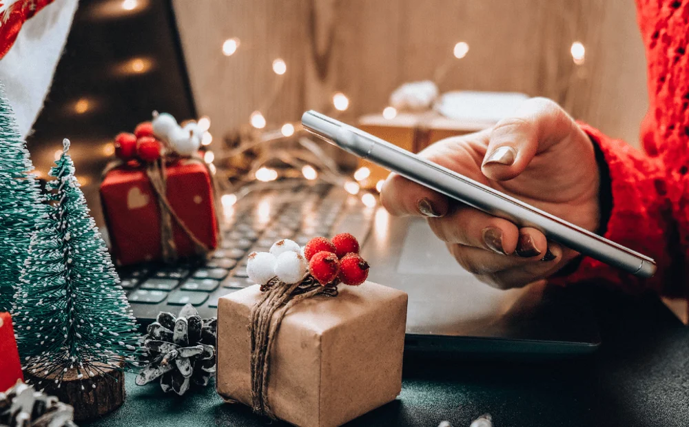 person sitting at a decorated desk scrolling on phone person sitting at a decorated desk scrolling on phone