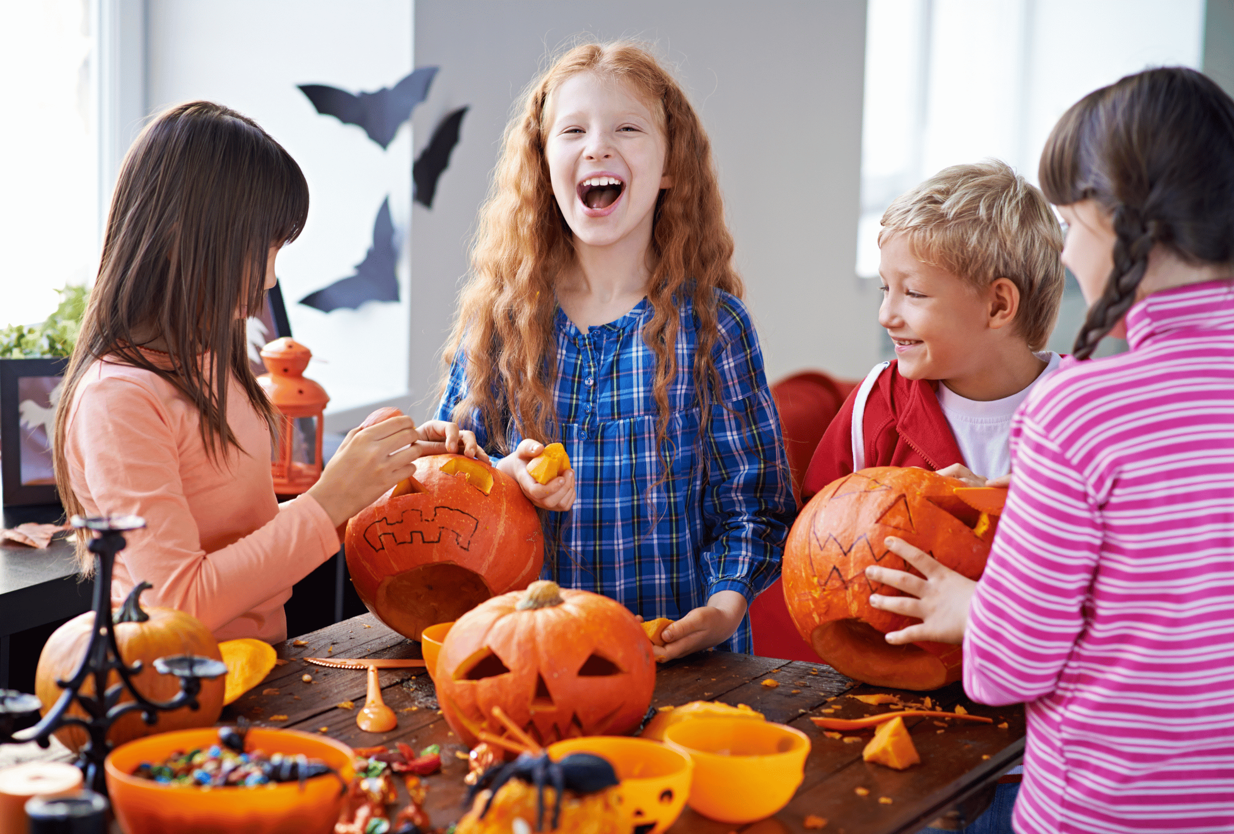 children carving pumpkins together