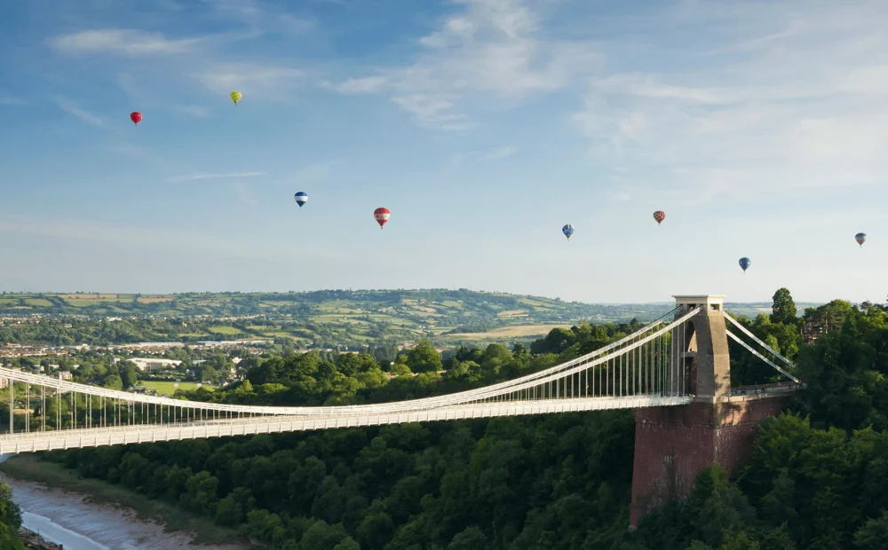 clifton suspension bridge with hot air balloons flying over clifton suspension bridge with hot air balloons flying over