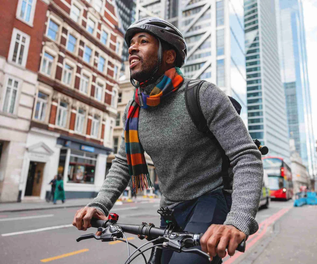 Man Riding A Bicycle In A City, Smiling