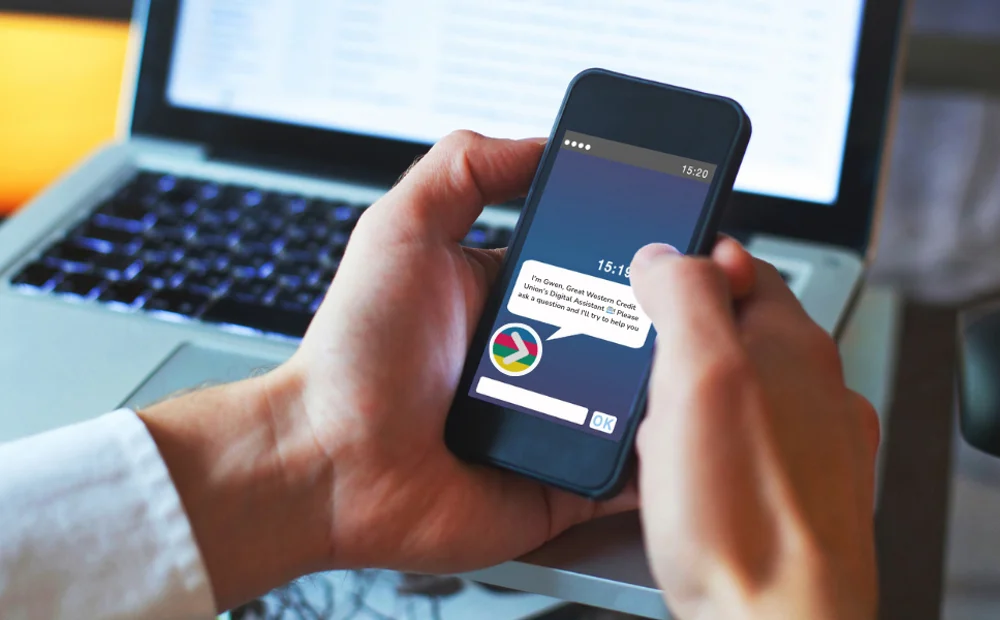 person holding smart phone using GWCU chat bot person holding smart phone using GWCU chat bot