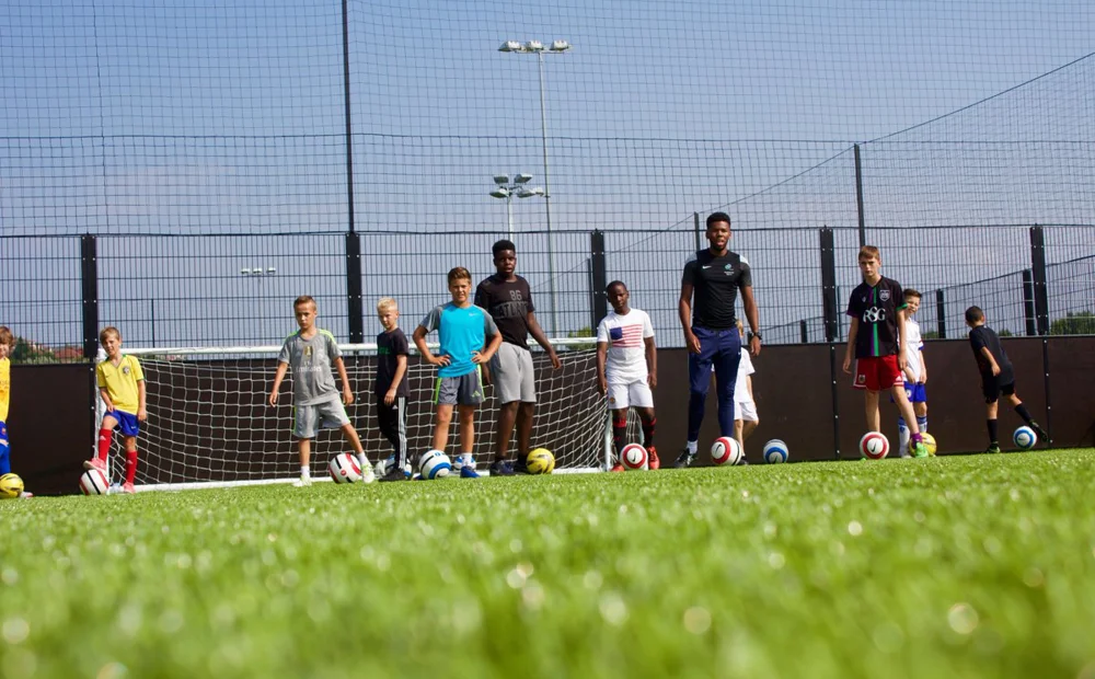 group of kids playing football group of kids playing football