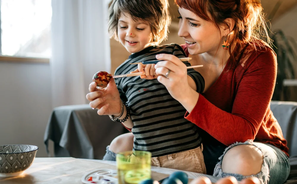 a mother and son painting eggs a mother and son painting eggs