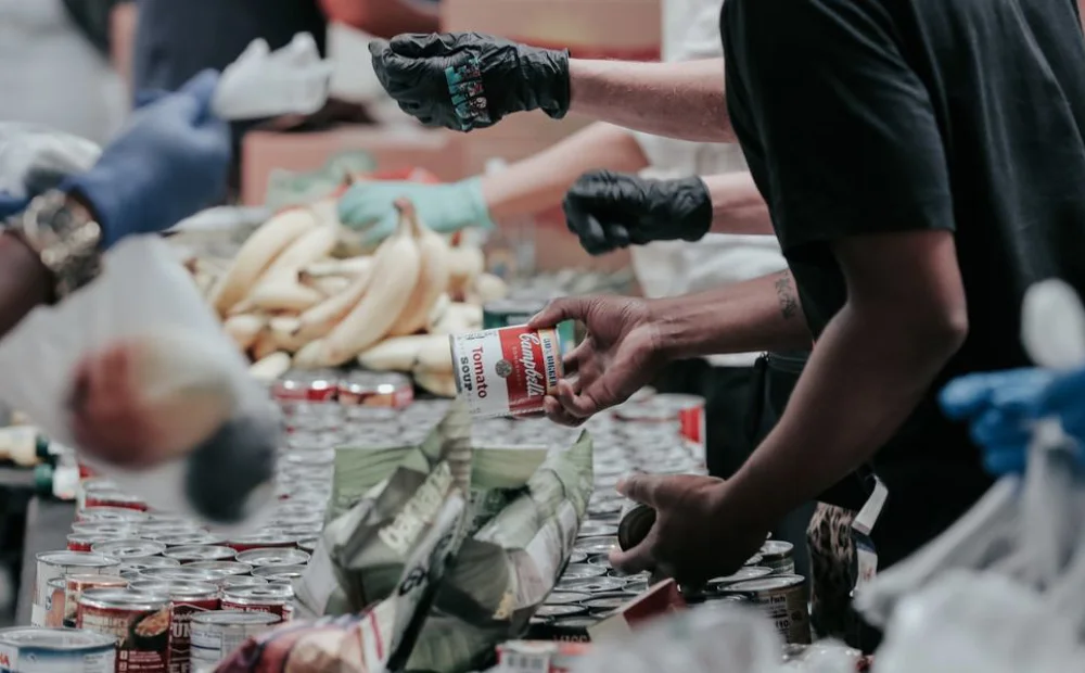 people passing canned food and bags people passing canned food and bags