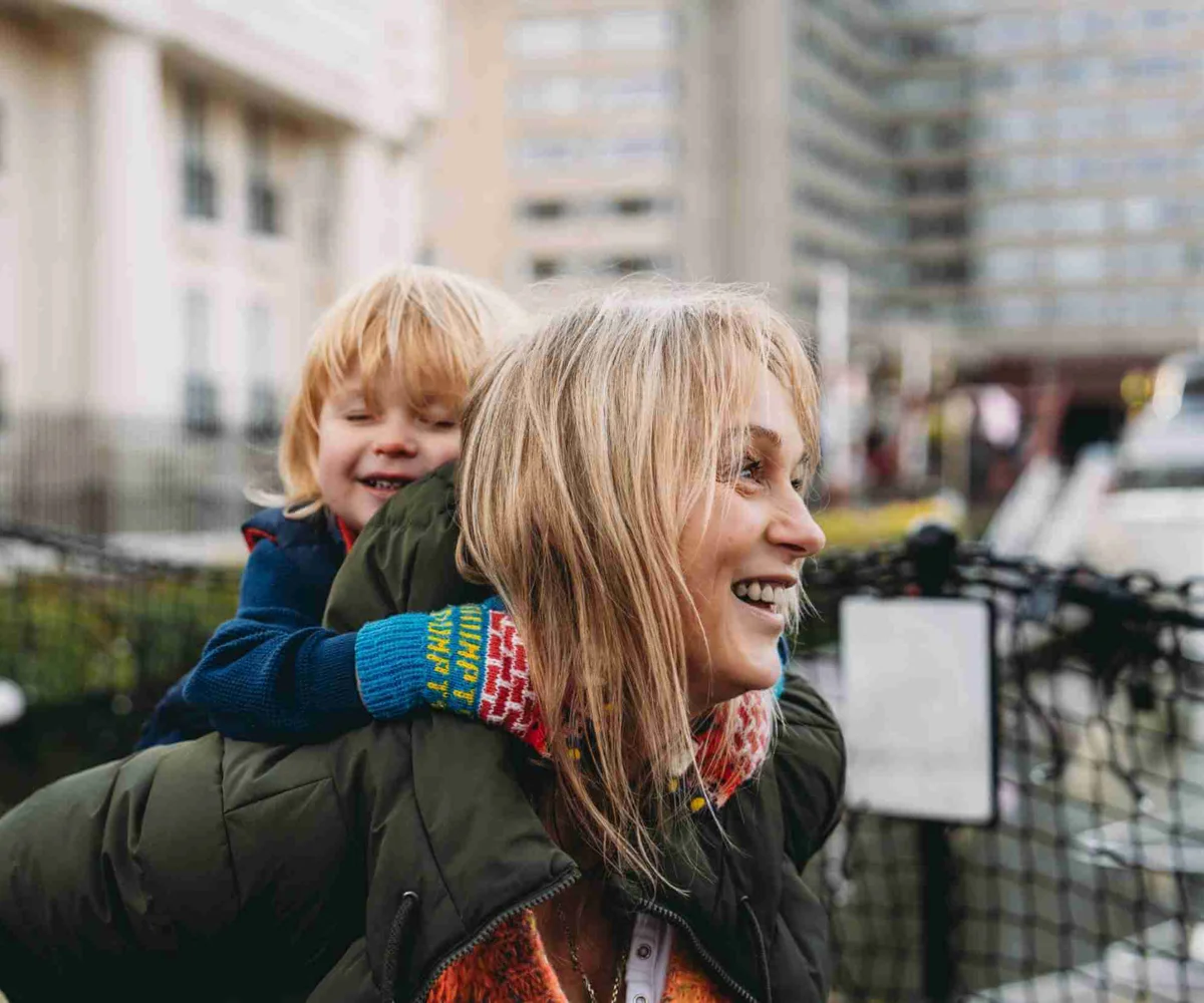 A Child On A Mother's Back Outside